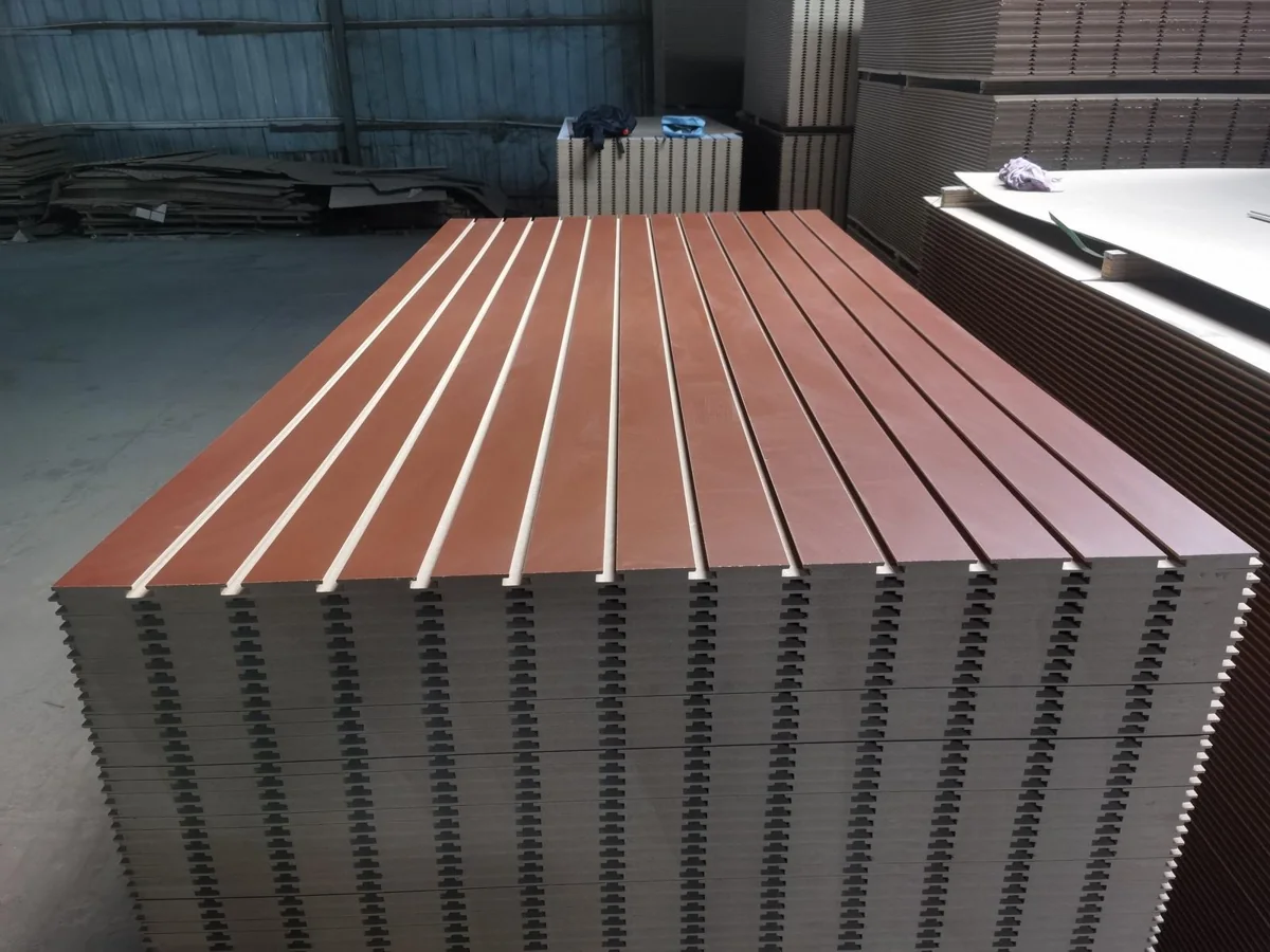 Brown melamine slotted MDF panels stacked at the inspection site