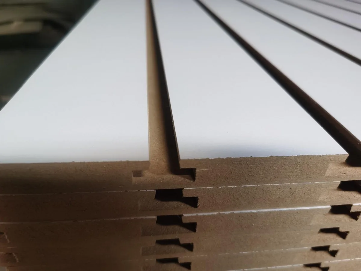 Close view of the shaped slot through the white melamine face into the MDF board