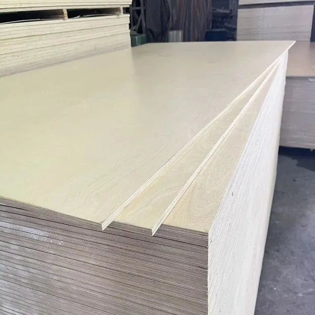 Pale-faced plywood sheets above a large stack of layered panel edges in a storage area.