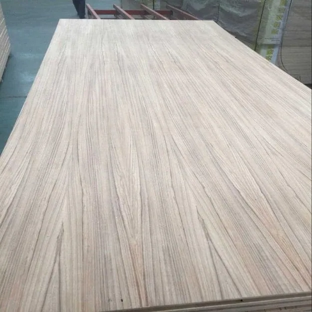 A broad wood-faced sheet with straight dark and light grain streaks in a workshop.