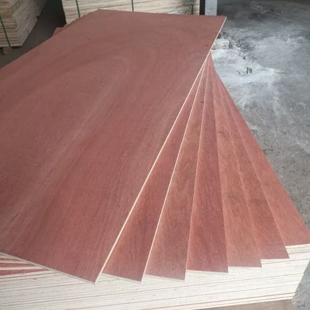Overlapping red-brown plywood sheets with pale veneer layers visible at their edges.