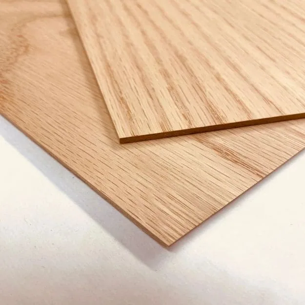 Overlapping oak-faced plywood panels showing pale brown grain and slim exposed edges.