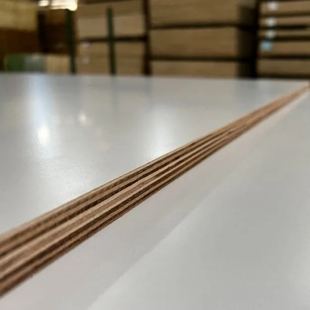 White-faced plywood sheets with exposed veneer layers and wrapped bundles in the background.